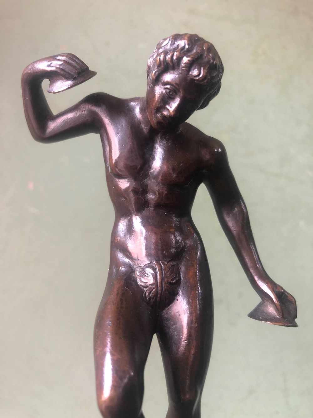 A pair of late nineteenth-century dark patinated bronze classical nude figures mounted on tall cylindrical dark marble column bases. View XIX