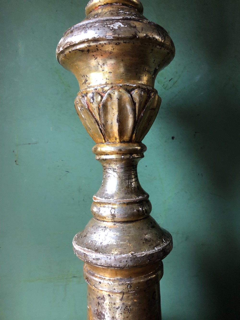 A pair of tall late eighteenth-century Italian carved giltwood altar candlesticks with turned baluster stems and mecca finish. View VII