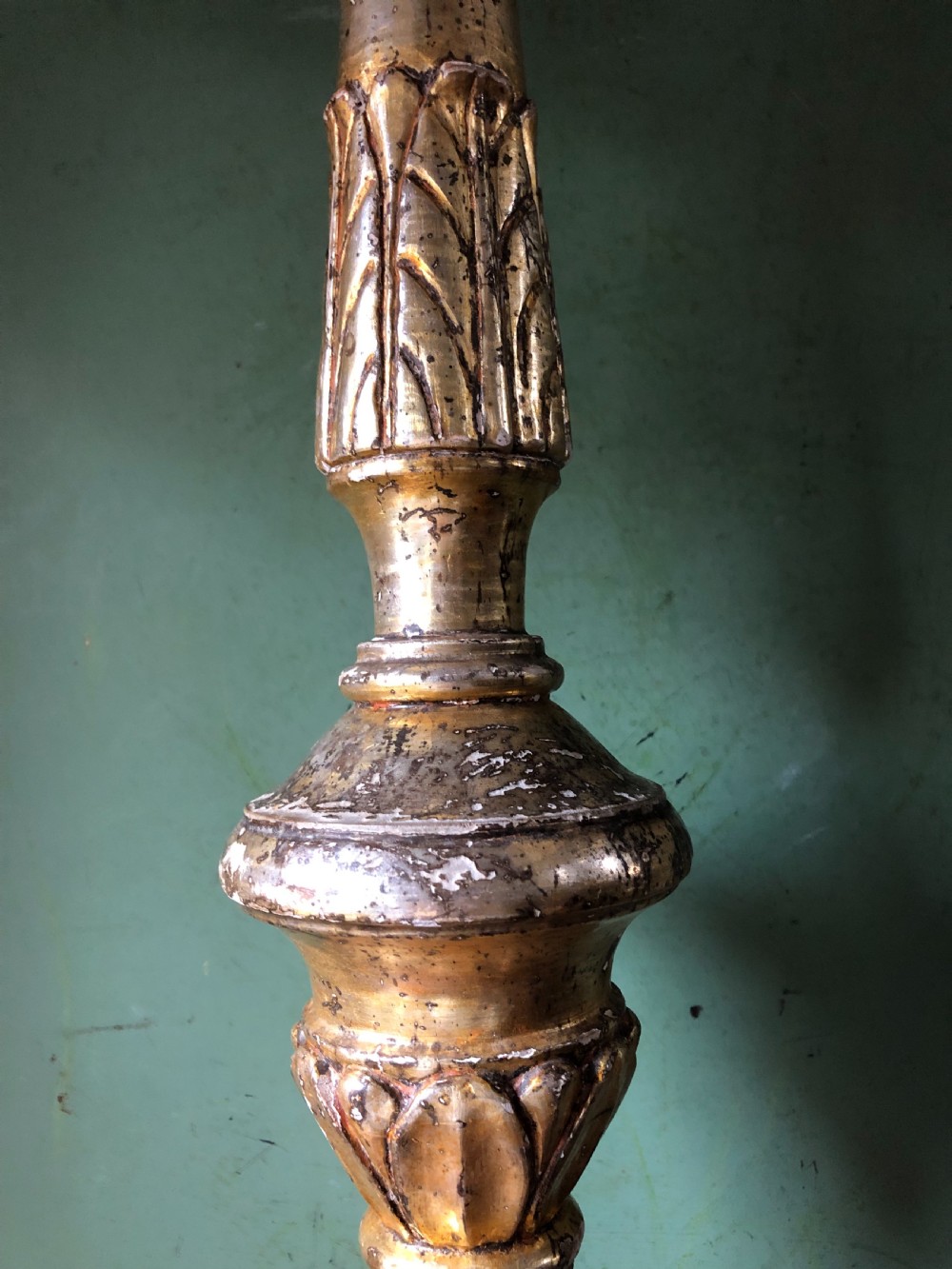 A pair of tall late eighteenth-century Italian carved giltwood altar candlesticks with turned baluster stems and mecca finish. View VIII