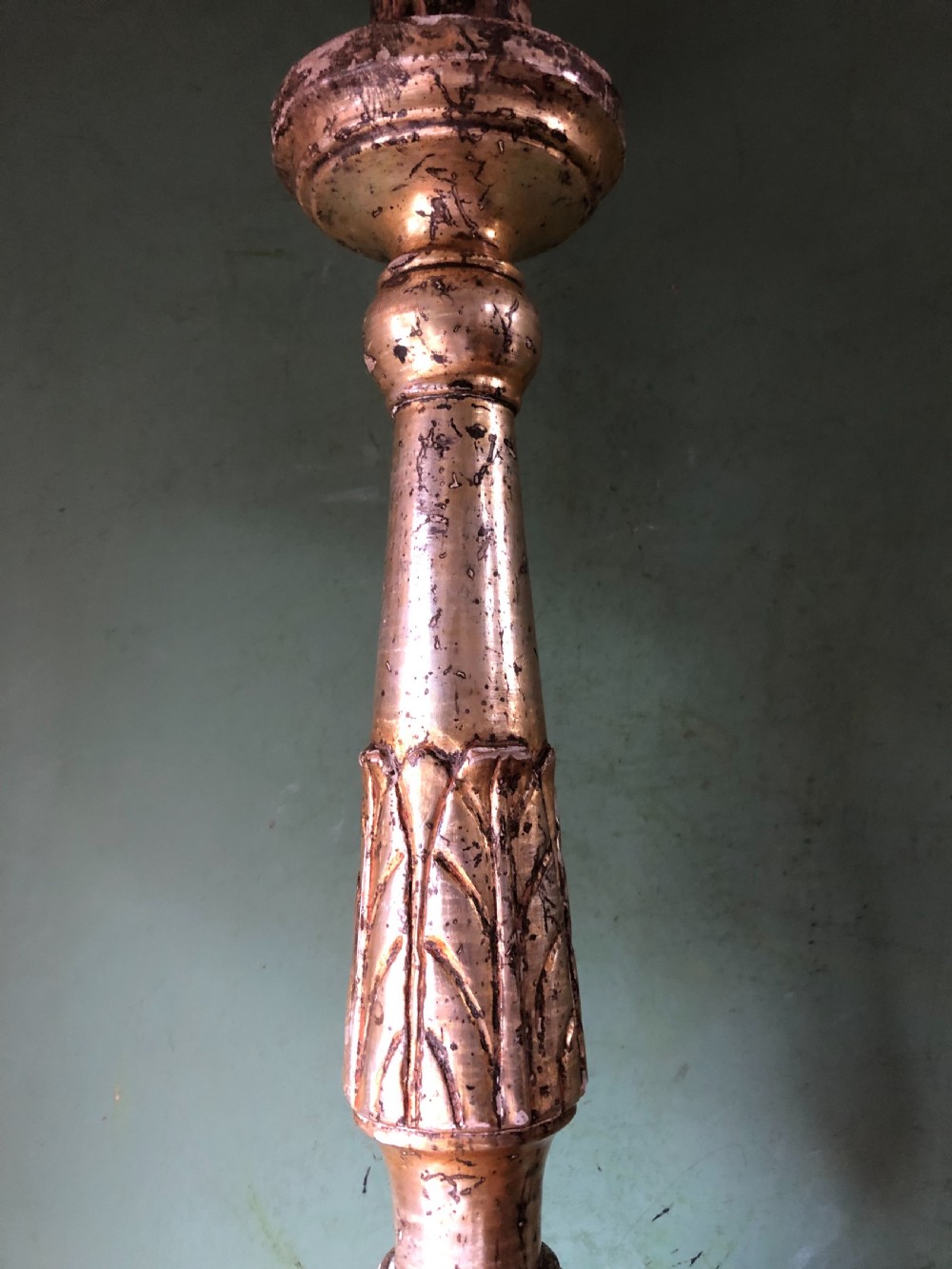 A pair of tall late eighteenth-century Italian carved giltwood altar candlesticks with turned baluster stems and mecca finish. View IX