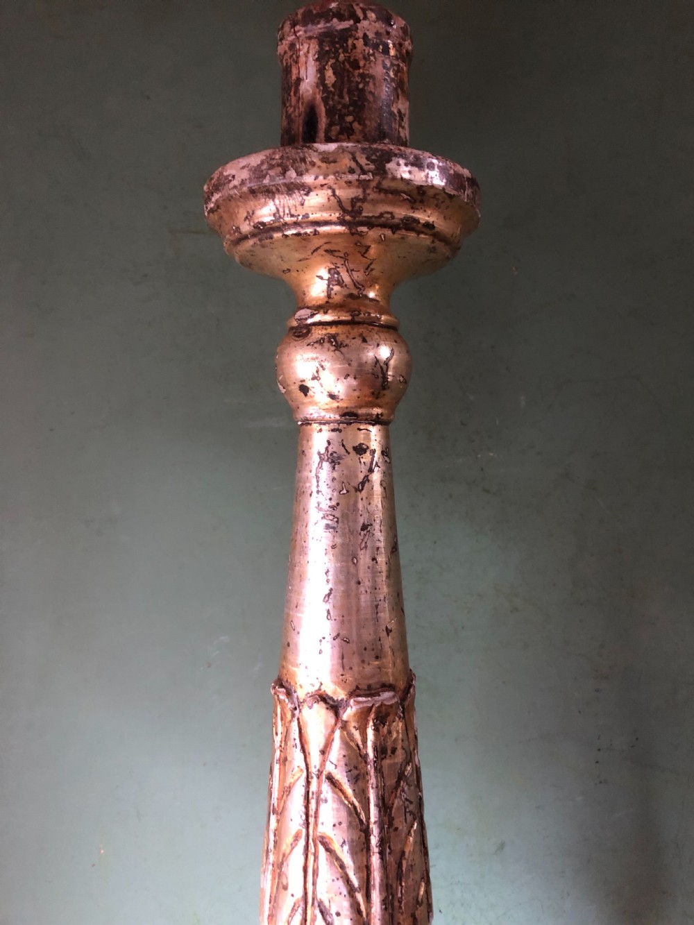 A pair of tall late eighteenth-century Italian carved giltwood altar candlesticks with turned baluster stems and mecca finish. View X