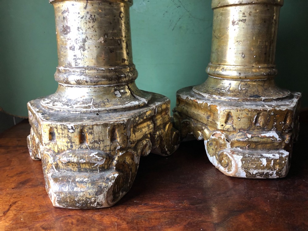 A pair of tall late eighteenth-century Italian carved giltwood altar candlesticks with turned baluster stems and mecca finish. View XII