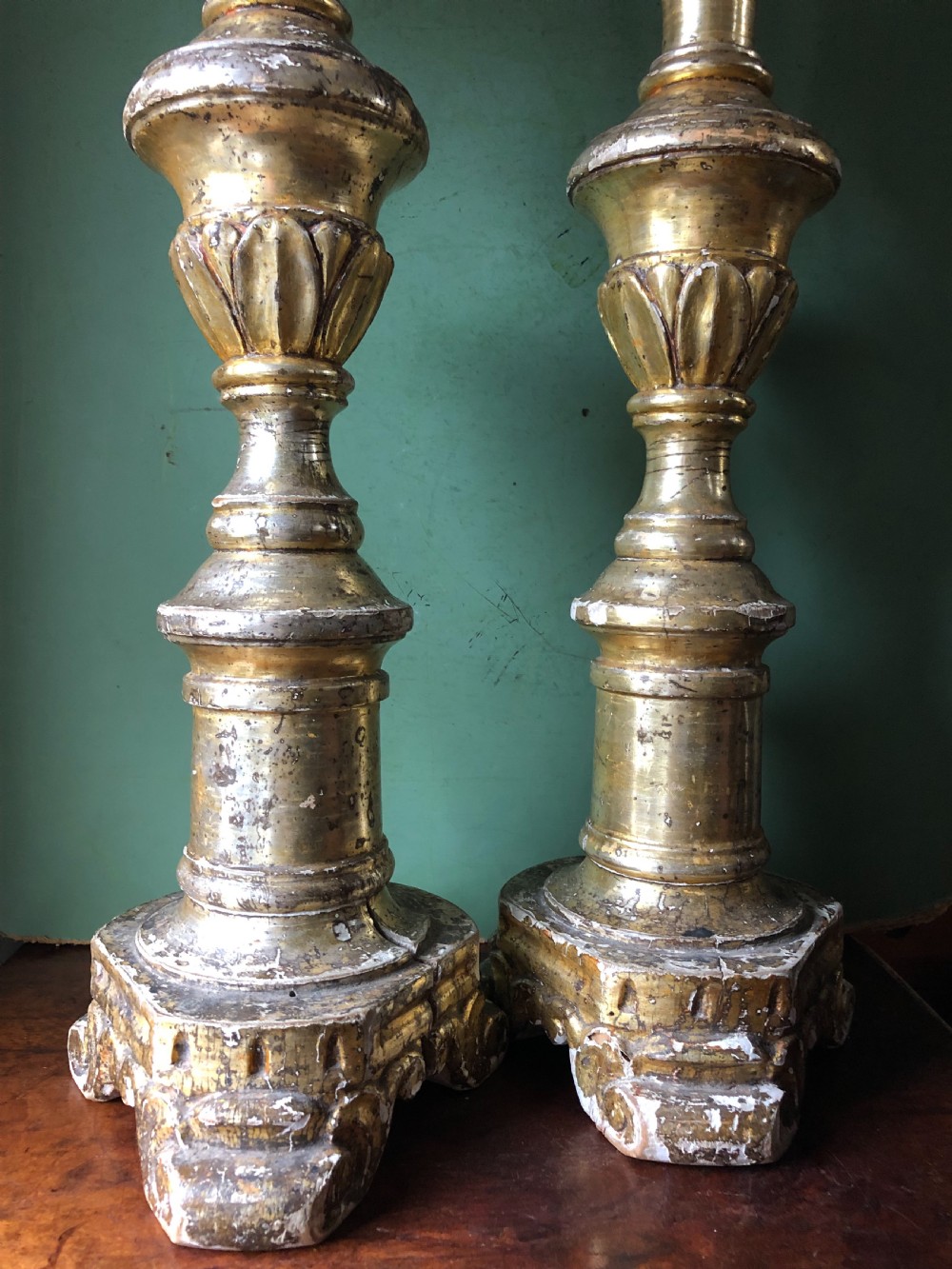 A pair of tall late eighteenth-century Italian carved giltwood altar candlesticks with turned baluster stems and mecca finish. View XIII
