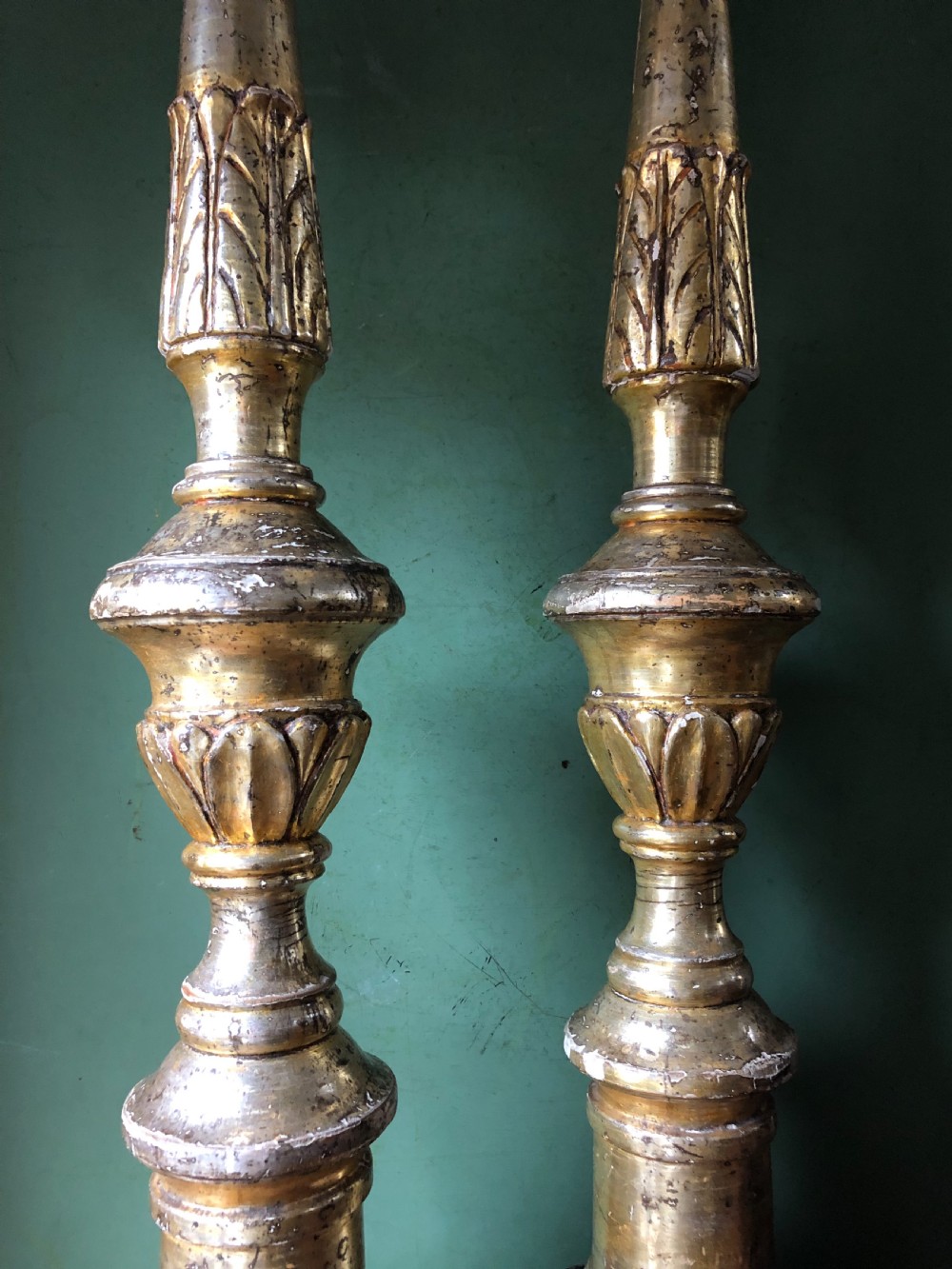 A pair of tall late eighteenth-century Italian carved giltwood altar candlesticks with turned baluster stems and mecca finish. View XV
