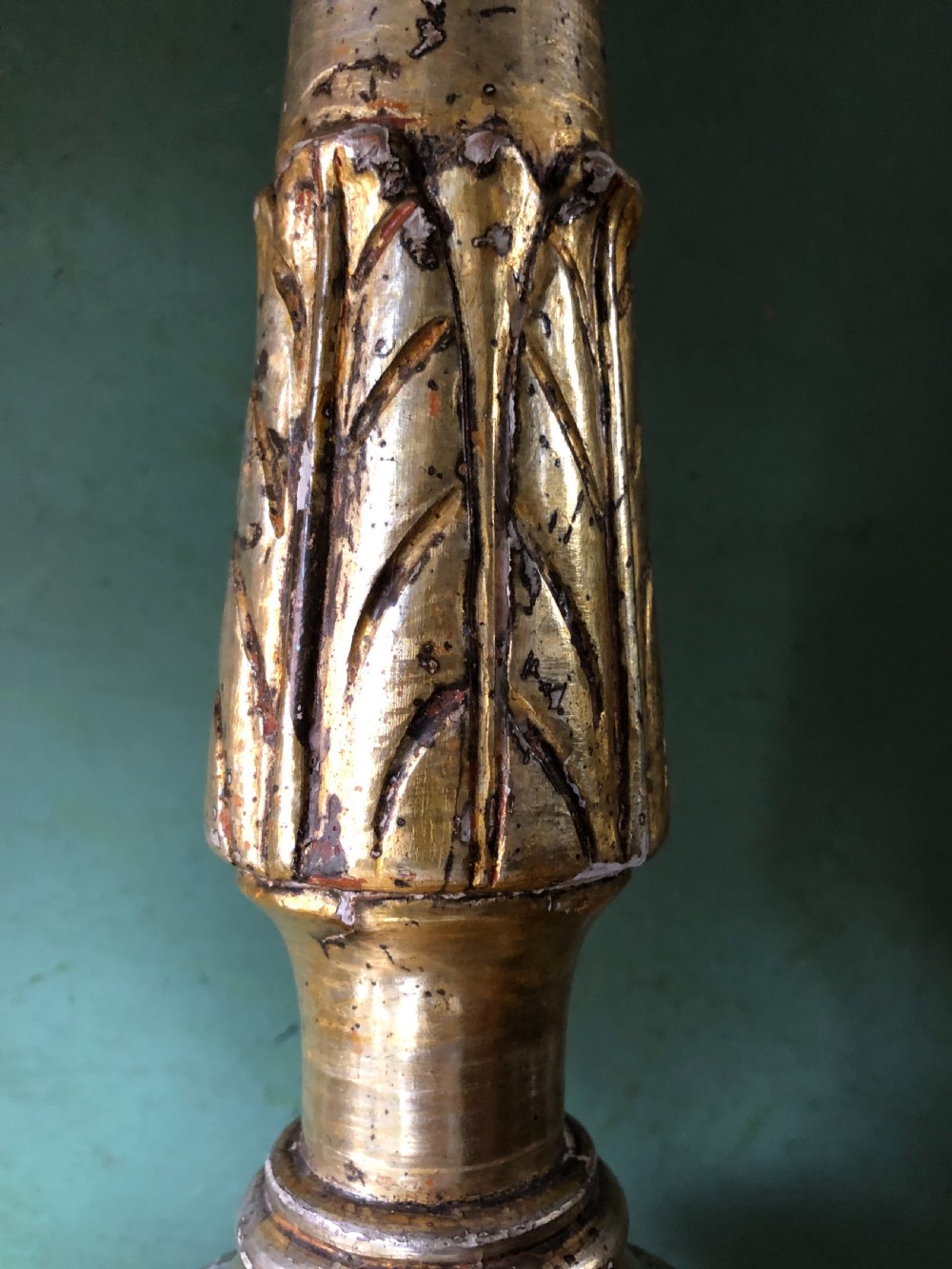 A pair of tall late eighteenth-century Italian carved giltwood altar candlesticks with turned baluster stems and mecca finish. View XVI