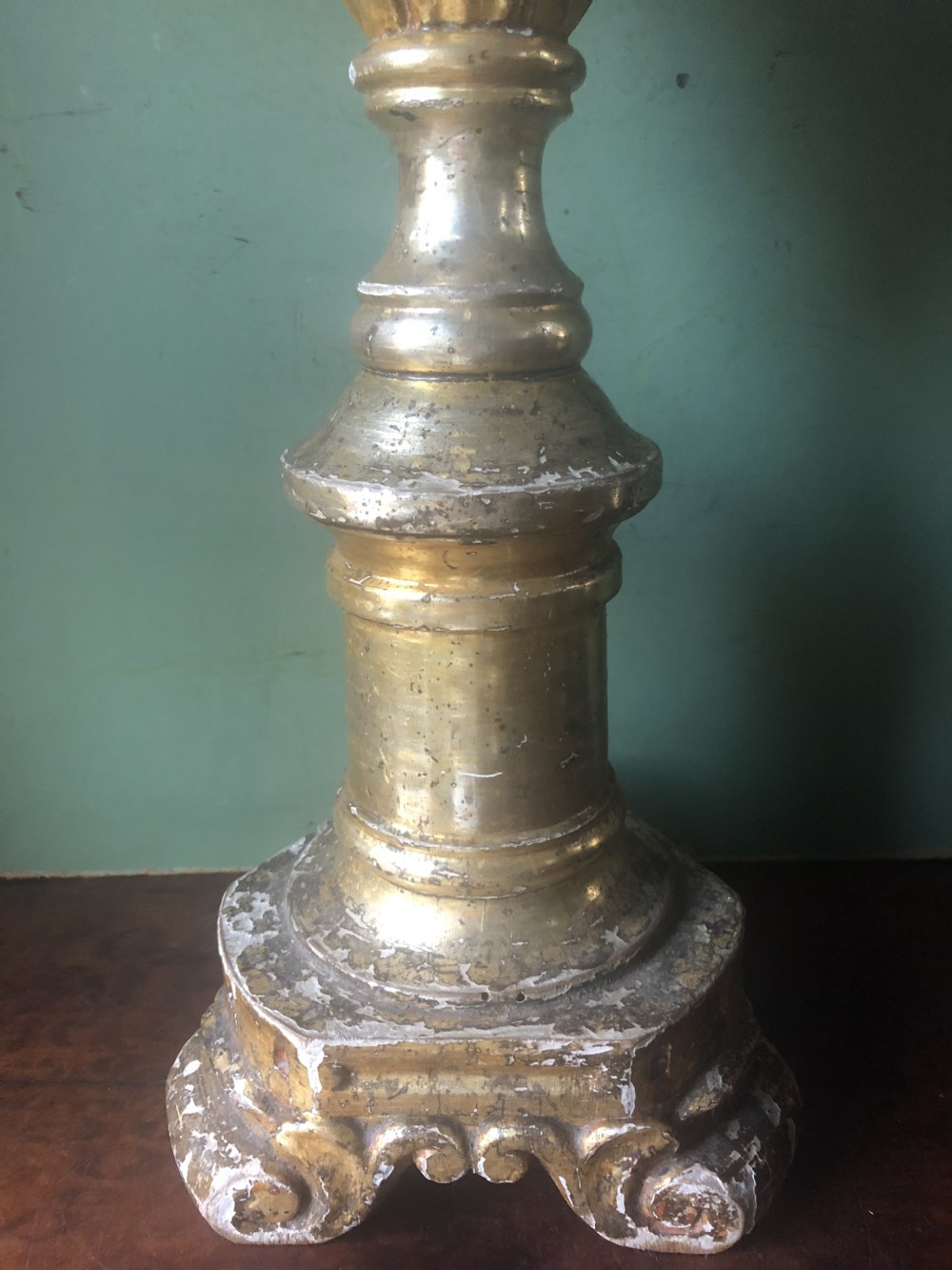 A pair of tall late eighteenth-century Italian carved giltwood altar candlesticks with turned baluster stems and mecca finish. View XIX