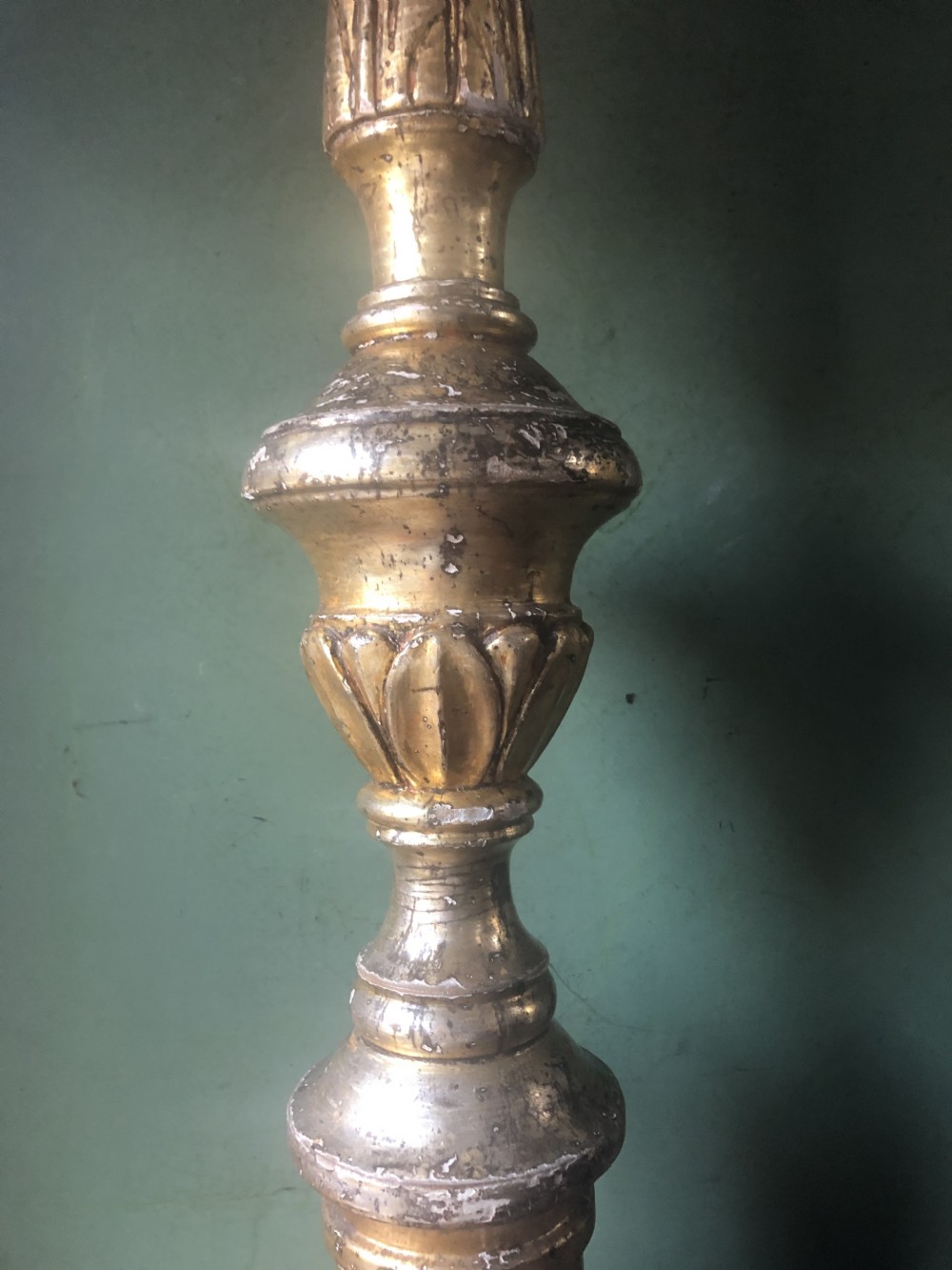 A pair of tall late eighteenth-century Italian carved giltwood altar candlesticks with turned baluster stems and mecca finish. View XX