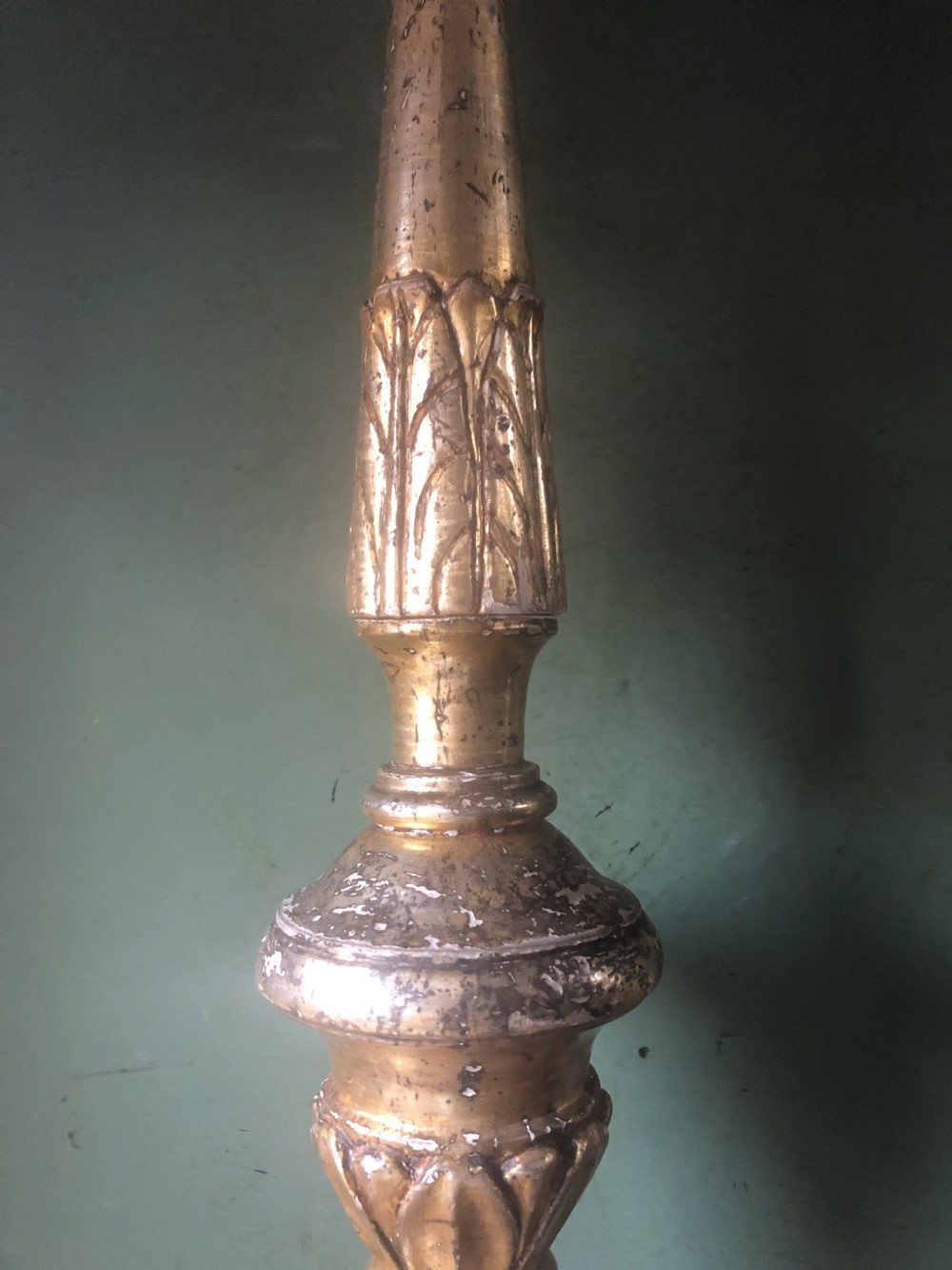 A pair of tall late eighteenth-century Italian carved giltwood altar candlesticks with turned baluster stems and mecca finish. View XXI