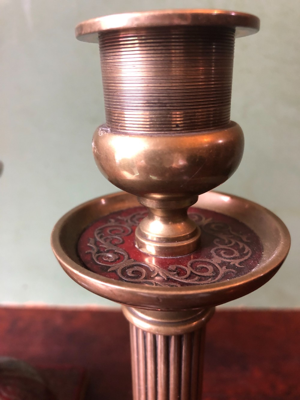 A pair of late 19th-century brass candlesticks featuring fluted columns supported by domed square bases inlaid with red tortoiseshell and engraved brass Boulle-work scroll motifs. View VI