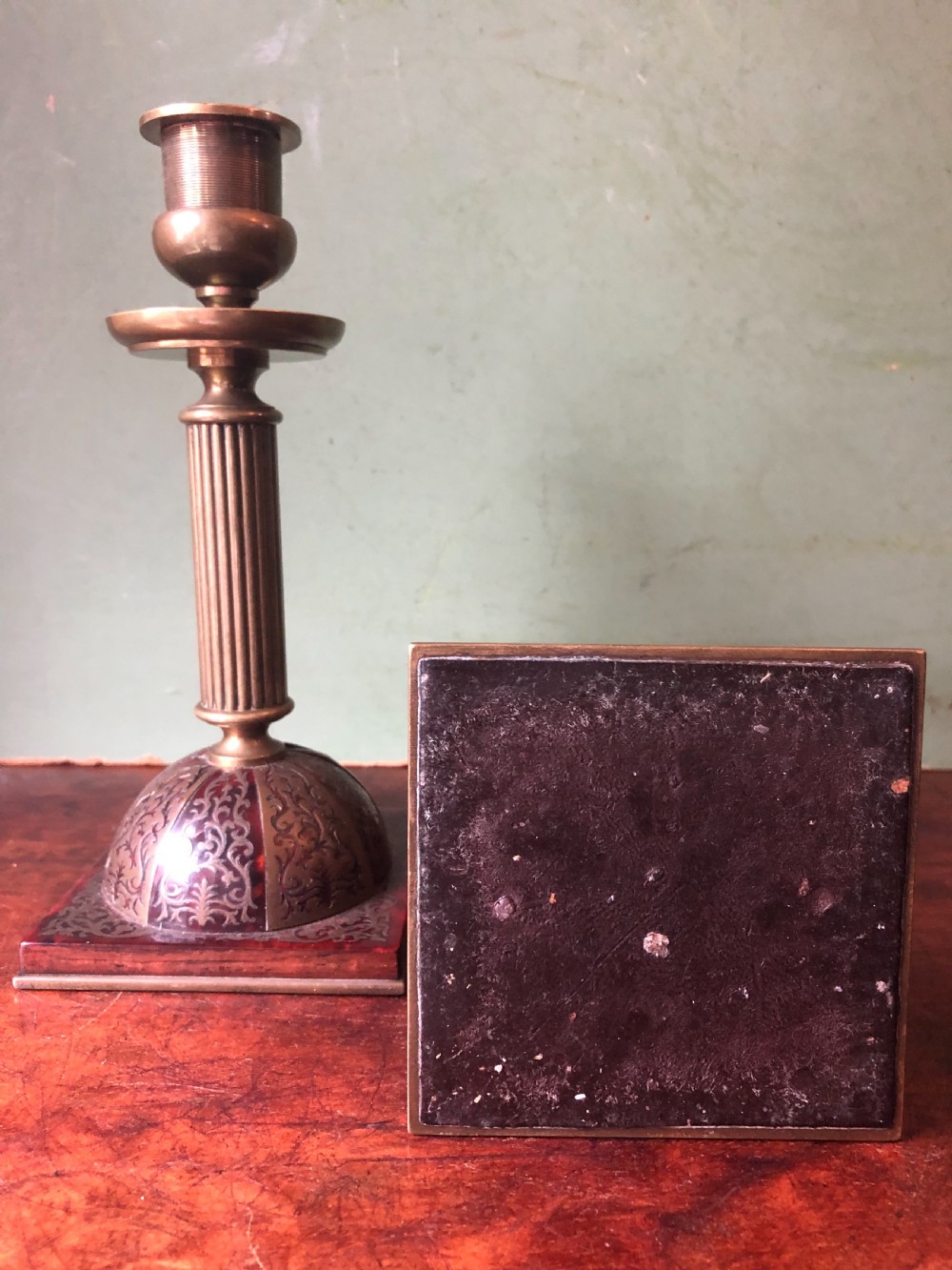 A pair of late 19th-century brass candlesticks featuring fluted columns supported by domed square bases inlaid with red tortoiseshell and engraved brass Boulle-work scroll motifs. View VII