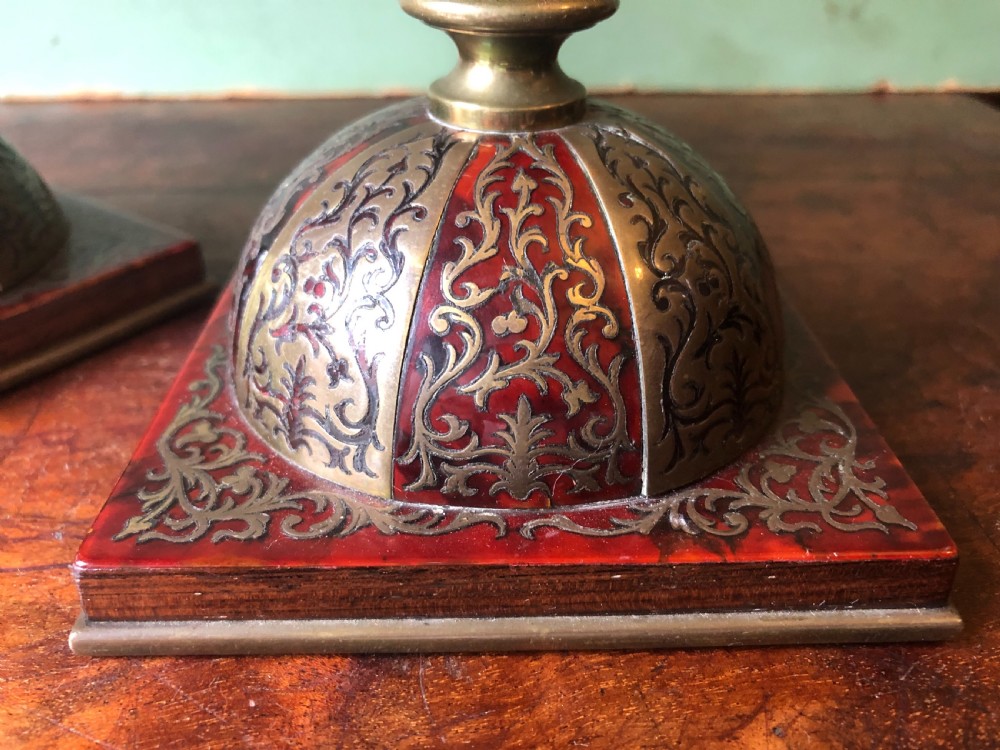 A pair of late 19th-century brass candlesticks featuring fluted columns supported by domed square bases inlaid with red tortoiseshell and engraved brass Boulle-work scroll motifs. View XI