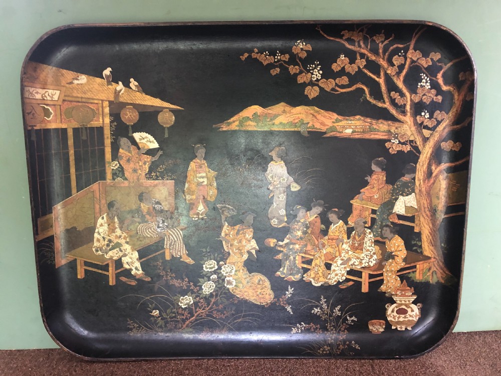 A mid-19th century rectangular black lacquer papier-mache tray decorated with hand-painted Japanese figures, traditional structures, and landscape scenery in gold and polychrome pigments. View III