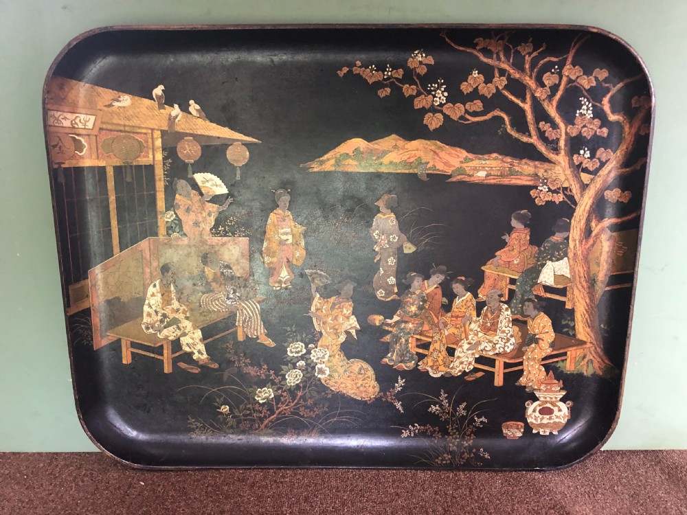 A mid-19th century rectangular black lacquer papier-mache tray decorated with hand-painted Japanese figures, traditional structures, and landscape scenery in gold and polychrome pigments. View IX