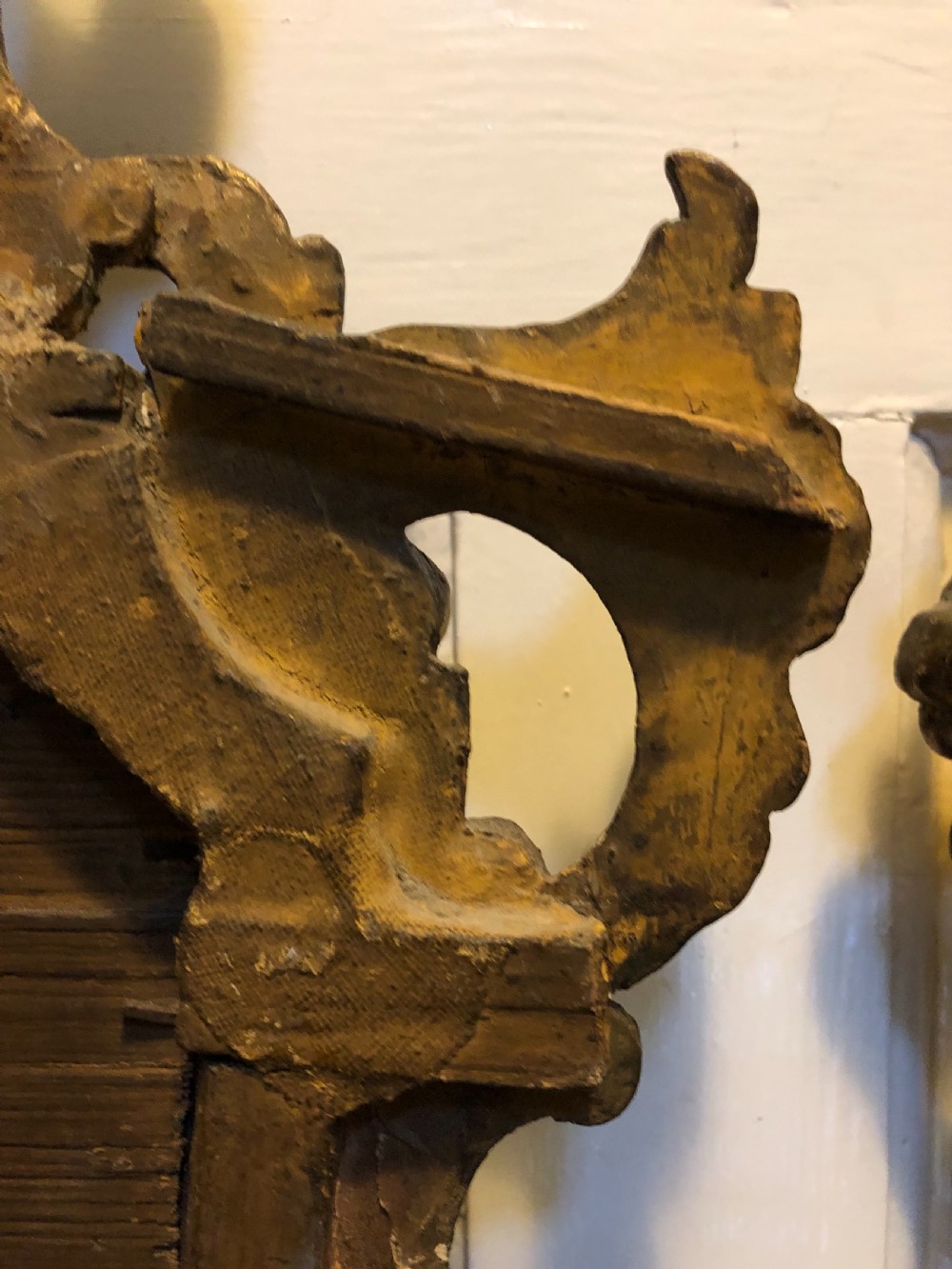 A pair of late eighteenth-century style carved giltwood pier mirrors featuring scrollwork cresting and shaped mirrored plates. View VIII
