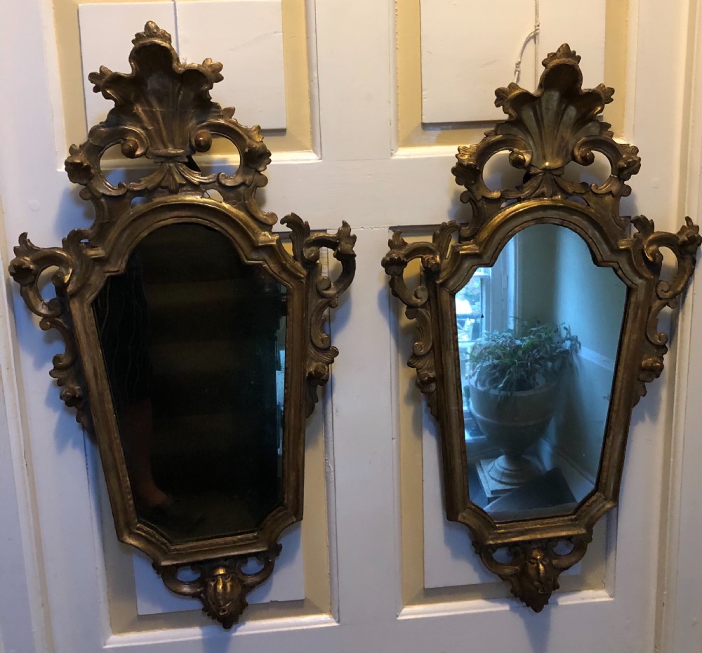 A pair of late eighteenth-century style carved giltwood pier mirrors featuring scrollwork cresting and shaped mirrored plates. View XXII