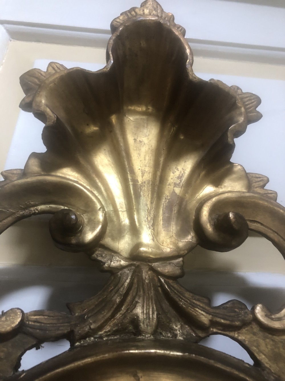 A pair of late eighteenth-century style carved giltwood pier mirrors featuring scrollwork cresting and shaped mirrored plates. View XXVII