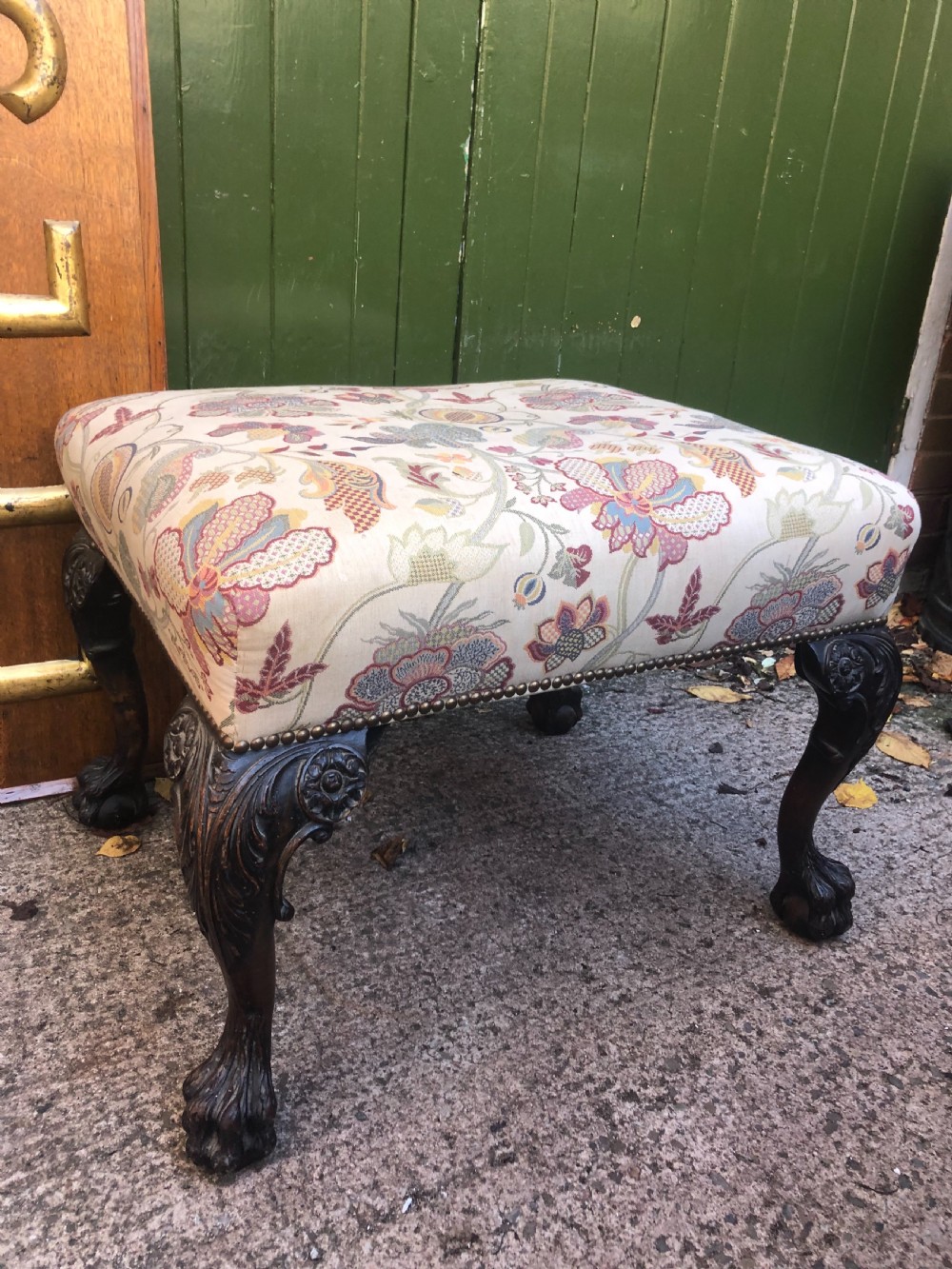 A rectangular floral upholstered stool featuring dark carved walnut cabriole legs with floral knees and claw-and-ball feet. View II