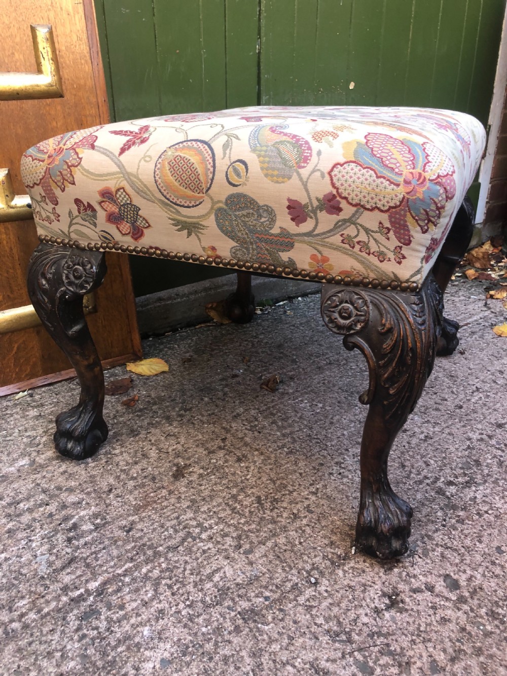 A rectangular floral upholstered stool featuring dark carved walnut cabriole legs with floral knees and claw-and-ball feet. View VII