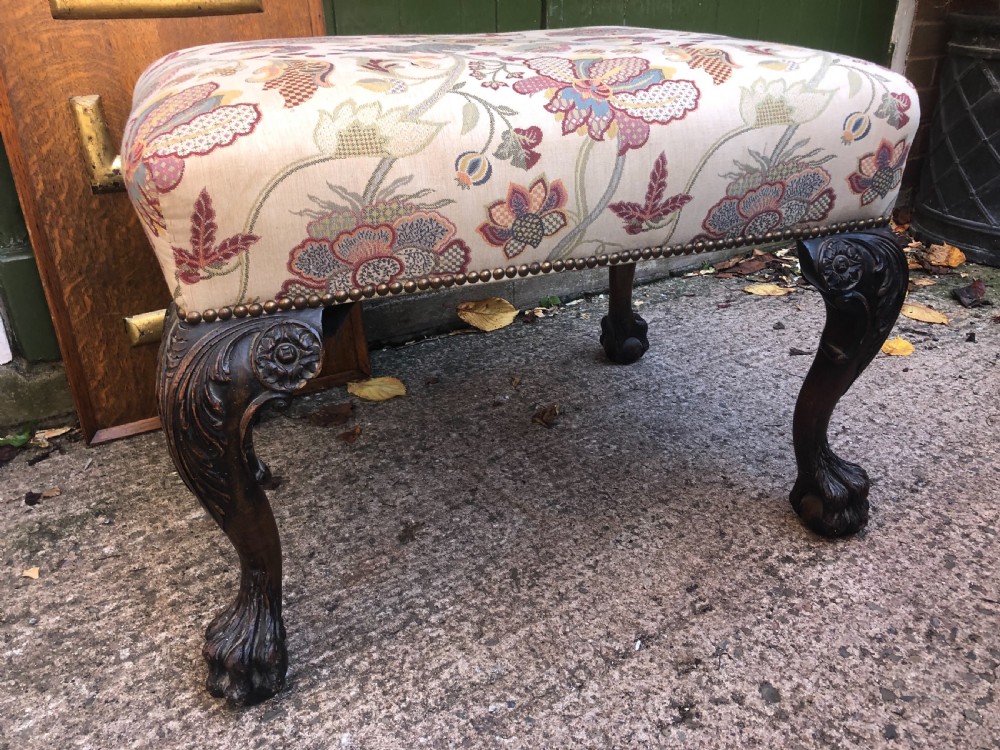 A rectangular floral upholstered stool featuring dark carved walnut cabriole legs with floral knees and claw-and-ball feet. View X