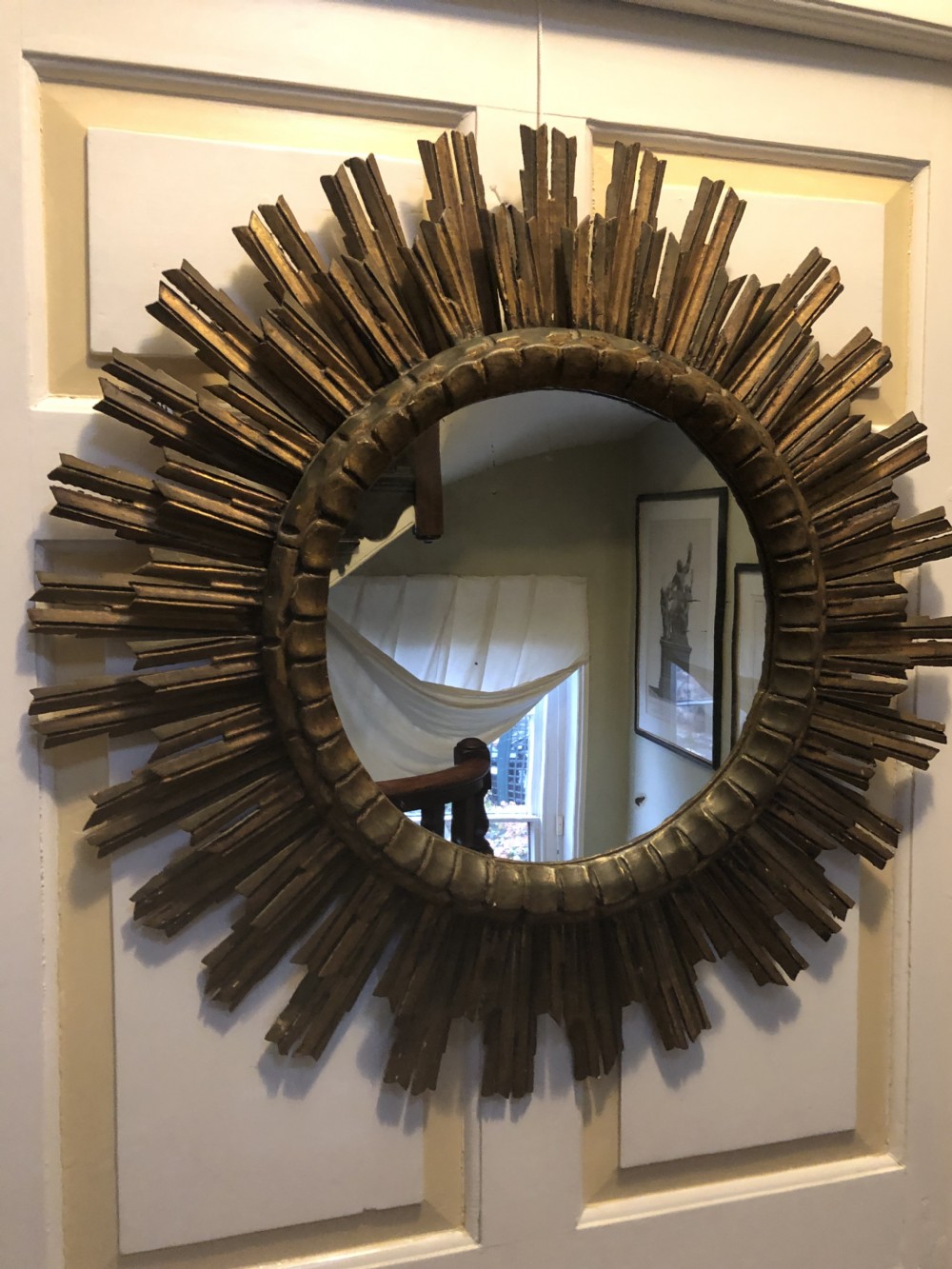 Highly decorative early C20th carved gilt-wood “sunburst” frame circular mirror .
