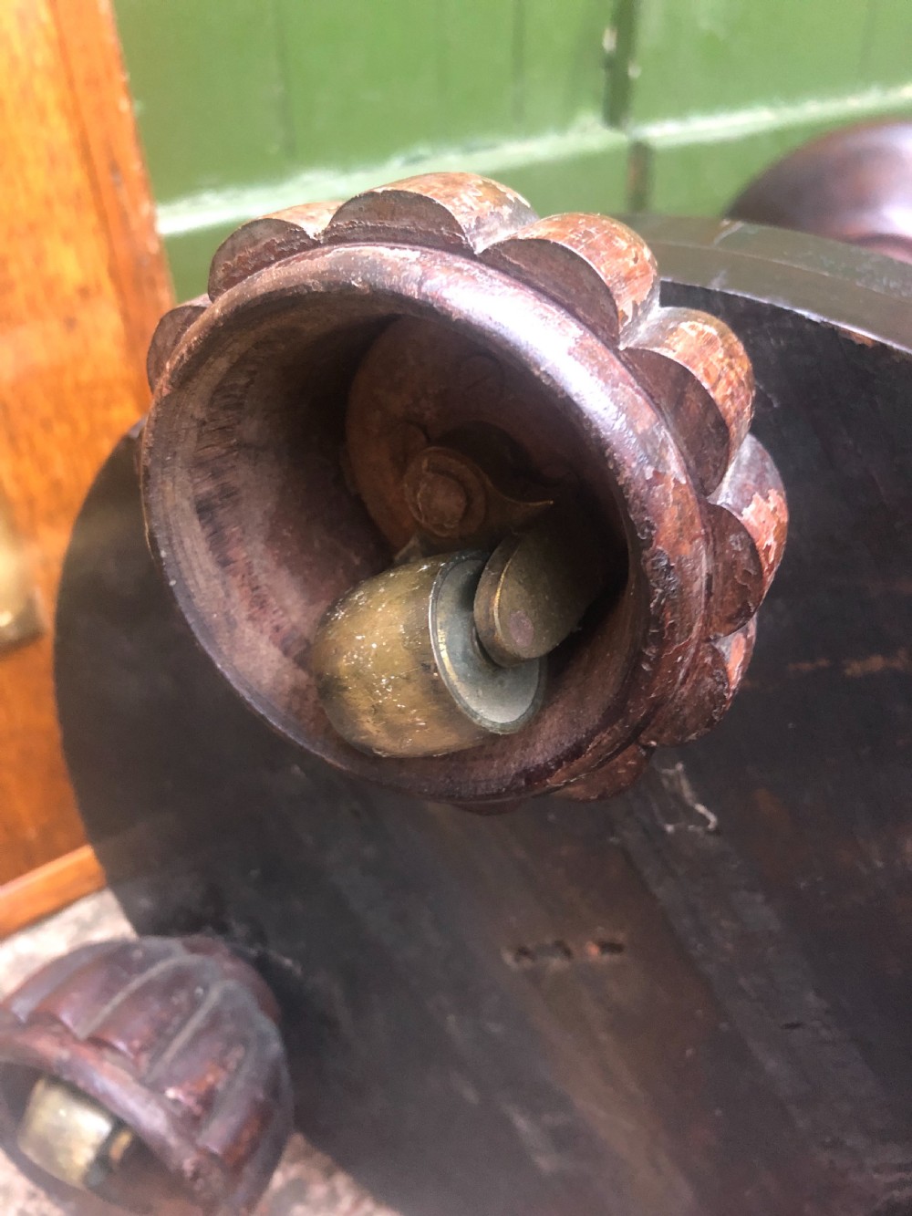 A dark brown turned rosewood columnar sculpture pedestal featuring a moulded top disc, architectural cylindrical shaft, and carved feet. View XIV