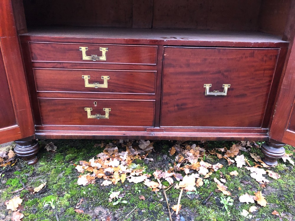 An early 19th-century William IV mahogany serving buffet featuring a carved scroll upstand, a top drawer with turned knobs, and twin panelled cupboard doors. View VII