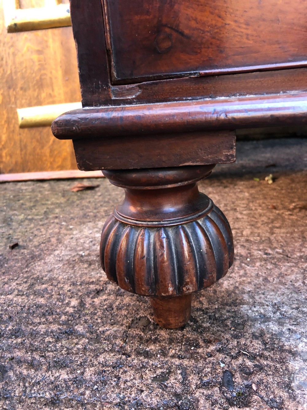 A William IV flame mahogany linen press featuring a double door upper cupboard with rope-twist side columns set above a lower chest of drawers with brass handles. View V