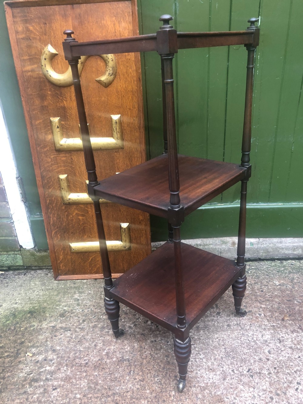 An early 19th-century George III mahogany three-tiered etagere with turned upright supports and brass castors. View VII