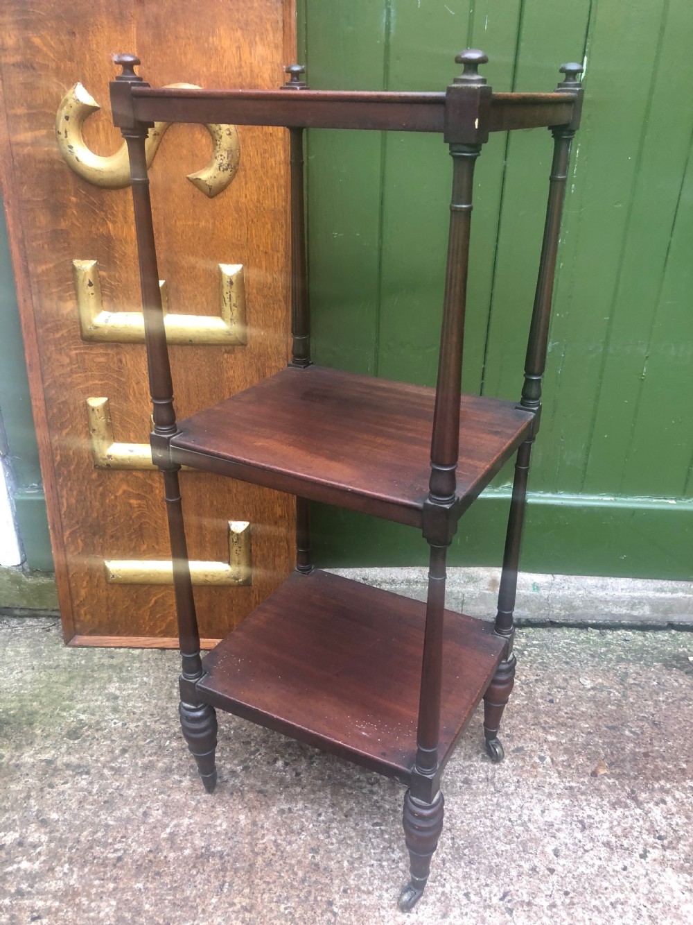 An early 19th-century George III mahogany three-tiered etagere with turned upright supports and brass castors. View IX