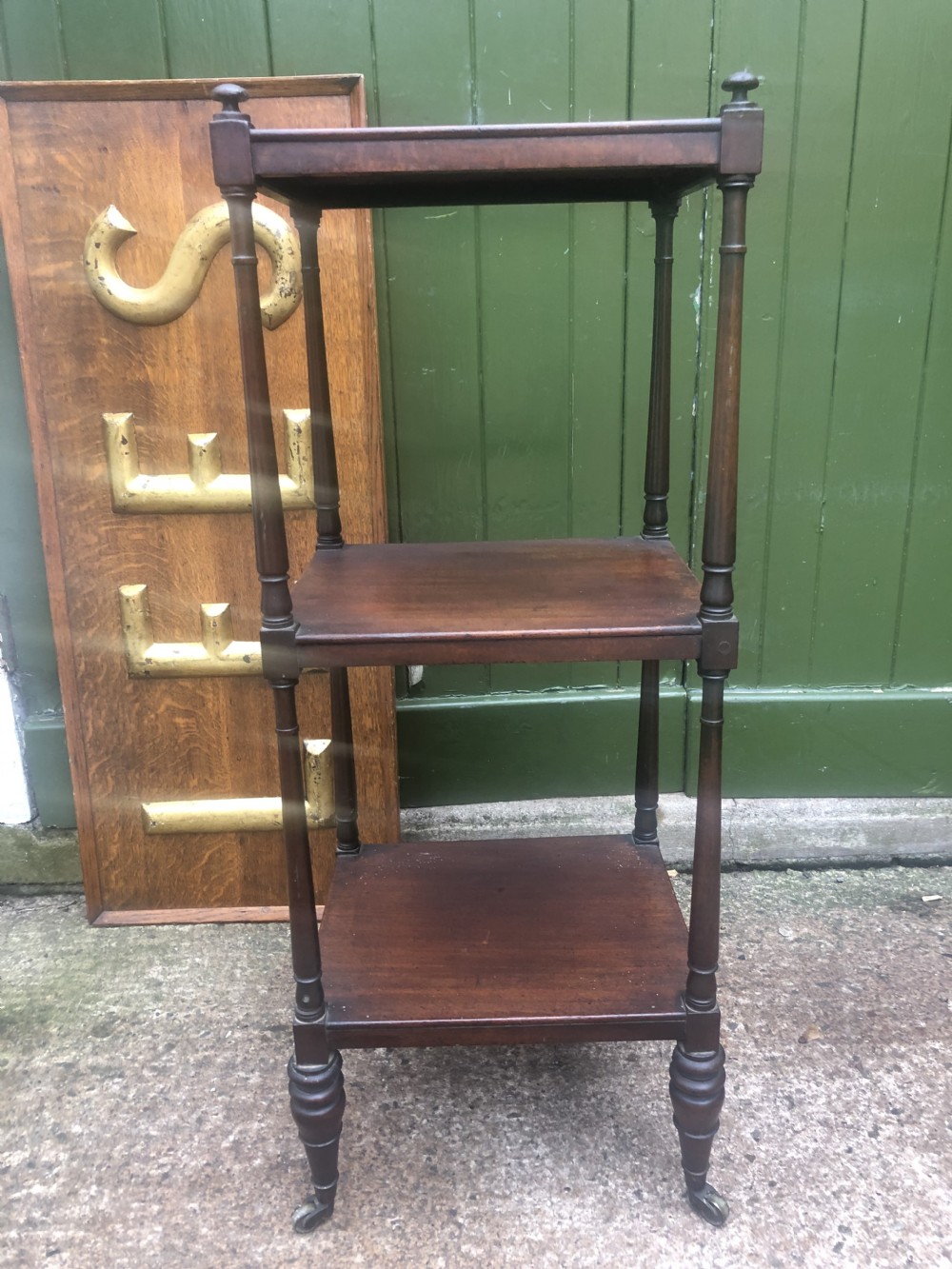 An early 19th-century George III mahogany three-tiered etagere with turned upright supports and brass castors. View XVII