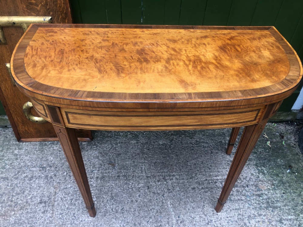 A late 18th-century George III satinwood fold-over card table featuring rosewood crossbanding, line inlay, and tapered square legs. View II