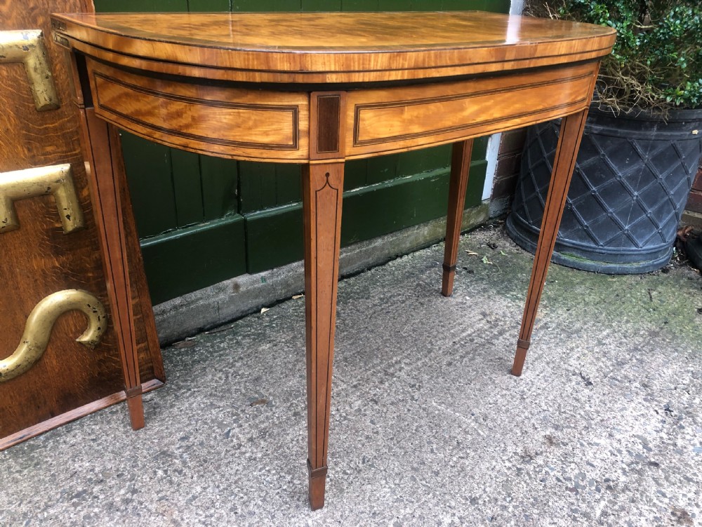 A late 18th-century George III satinwood fold-over card table featuring rosewood crossbanding, line inlay, and tapered square legs. View III