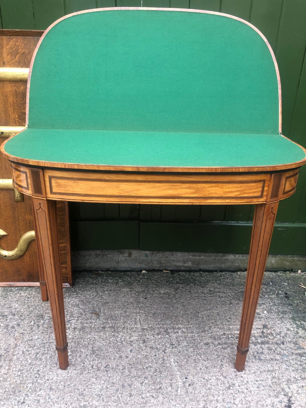 A late 18th-century George III satinwood fold-over card table featuring rosewood crossbanding, line inlay, and tapered square legs. View VII