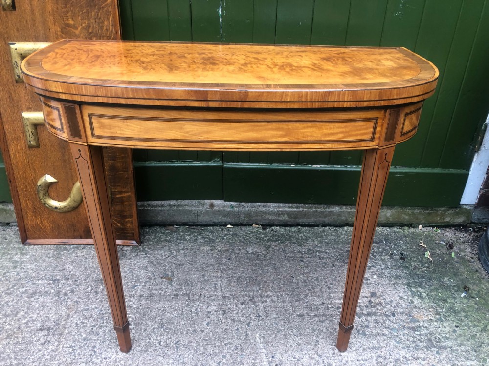 A late 18th-century George III satinwood fold-over card table featuring rosewood crossbanding, line inlay, and tapered square legs. View VIII