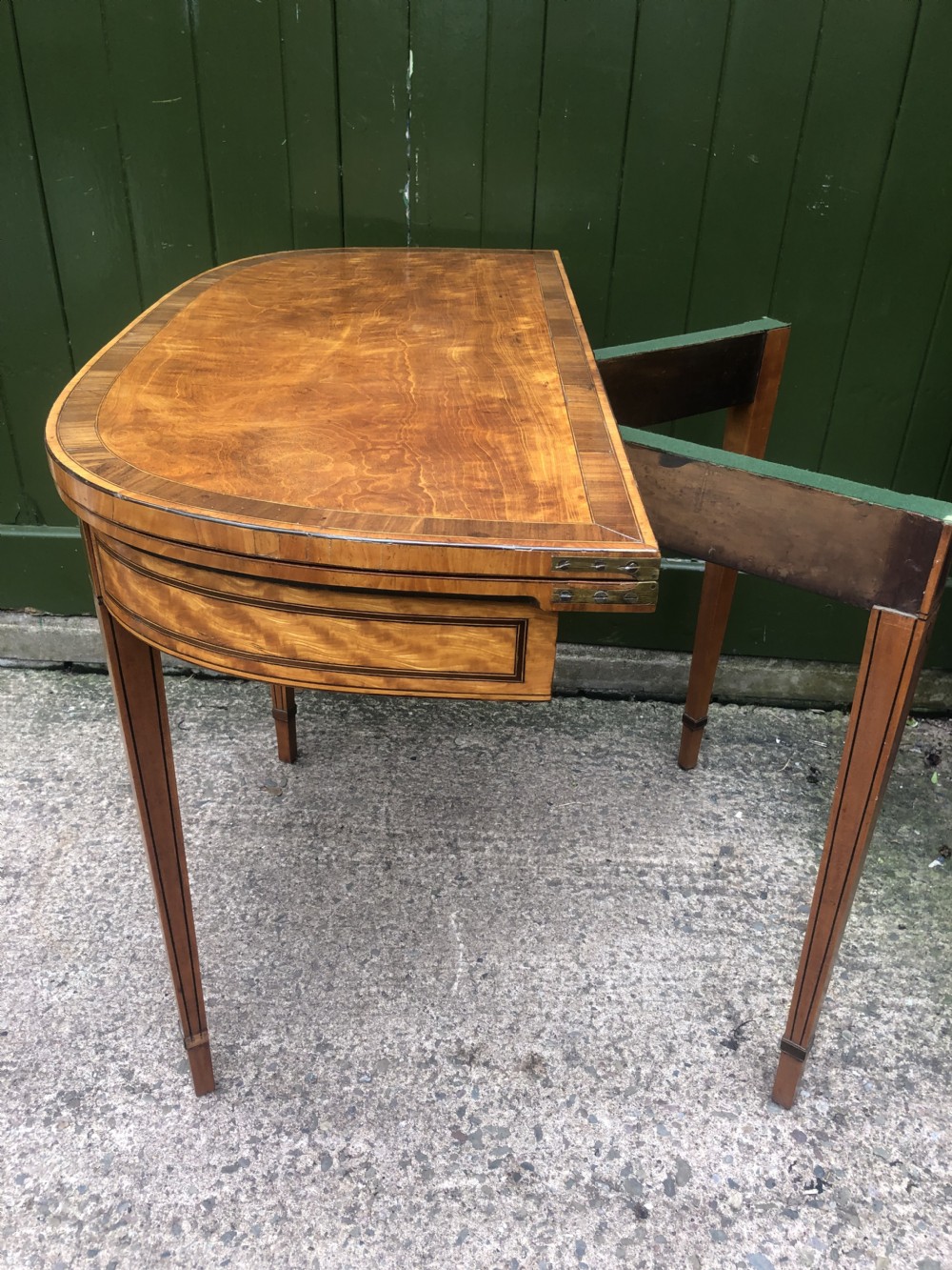 A late 18th-century George III satinwood fold-over card table featuring rosewood crossbanding, line inlay, and tapered square legs. View XI