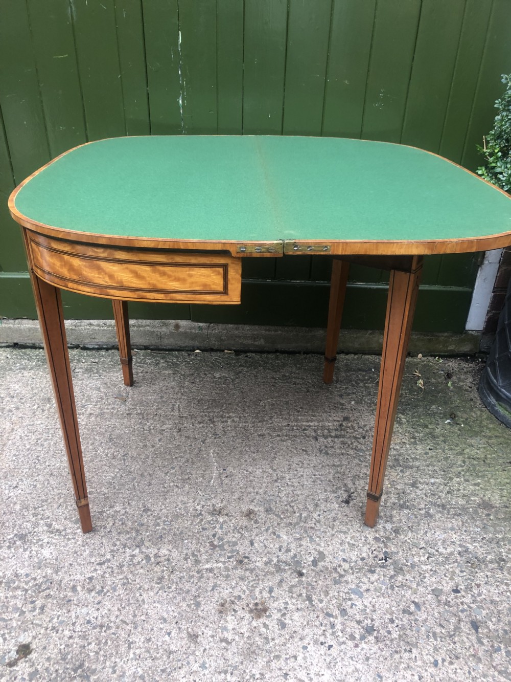 A late 18th-century George III satinwood fold-over card table featuring rosewood crossbanding, line inlay, and tapered square legs. View XII