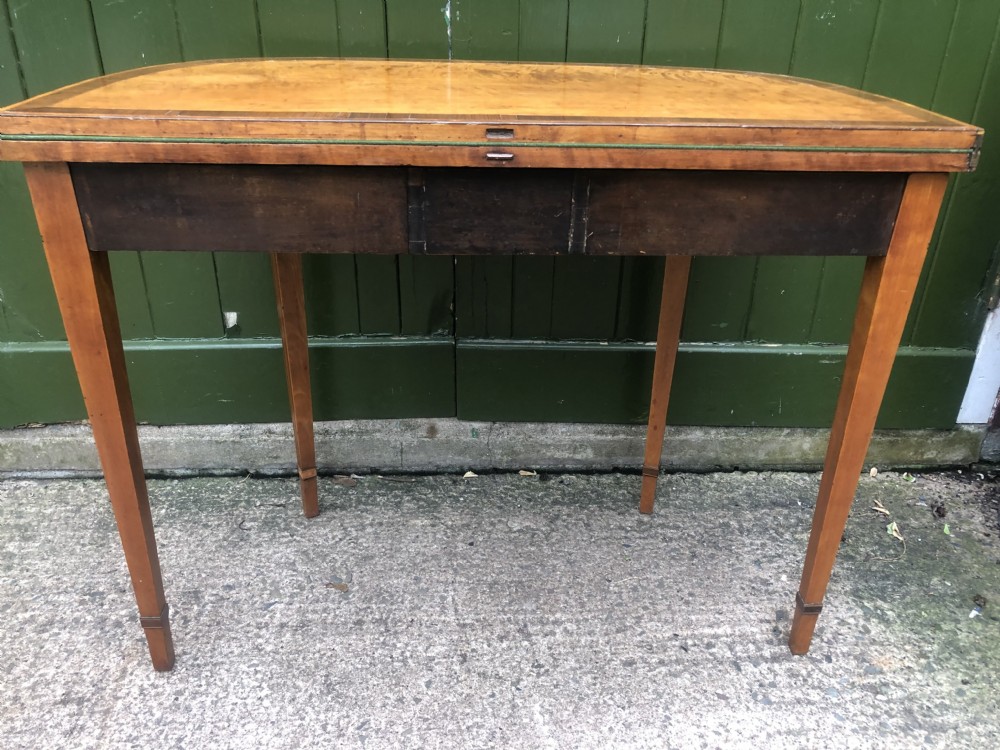 A late 18th-century George III satinwood fold-over card table featuring rosewood crossbanding, line inlay, and tapered square legs. View XVI