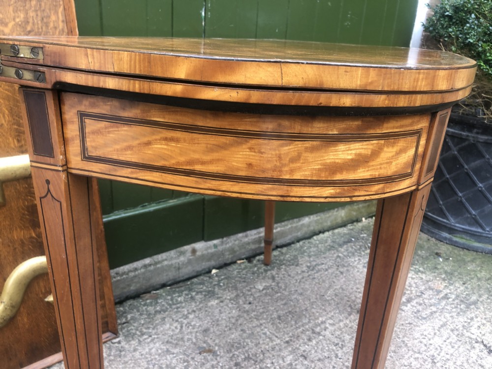 A late 18th-century George III satinwood fold-over card table featuring rosewood crossbanding, line inlay, and tapered square legs. View XXIII