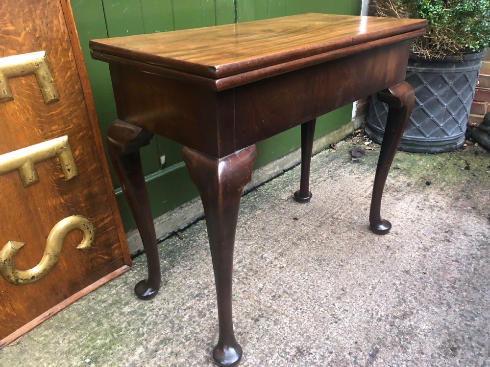 A mid-18th-century George II mahogany fold-over gaming table featuring elegant cabriole legs with pad feet. View III