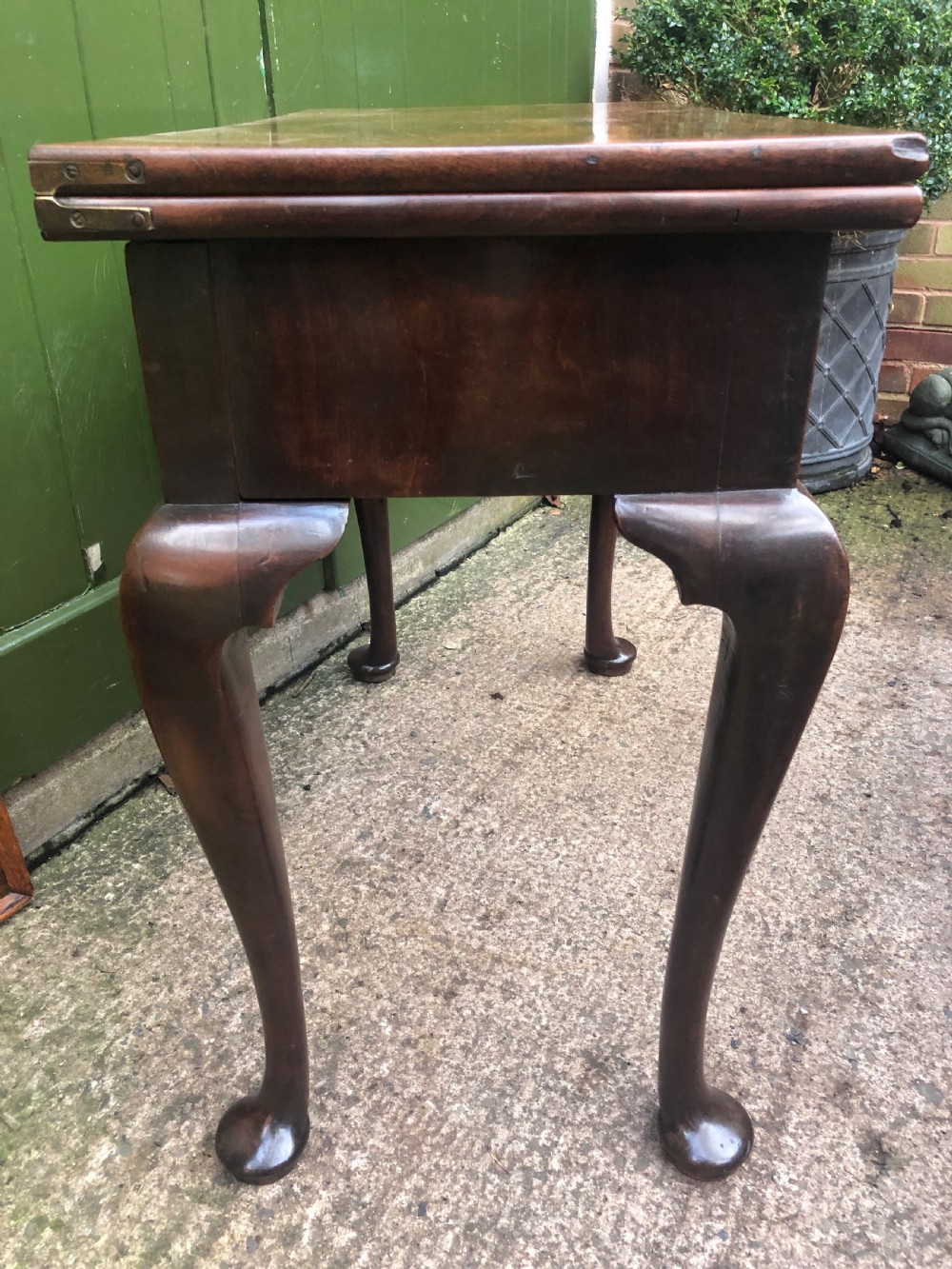 A mid-18th-century George II mahogany fold-over gaming table featuring elegant cabriole legs with pad feet. View IV