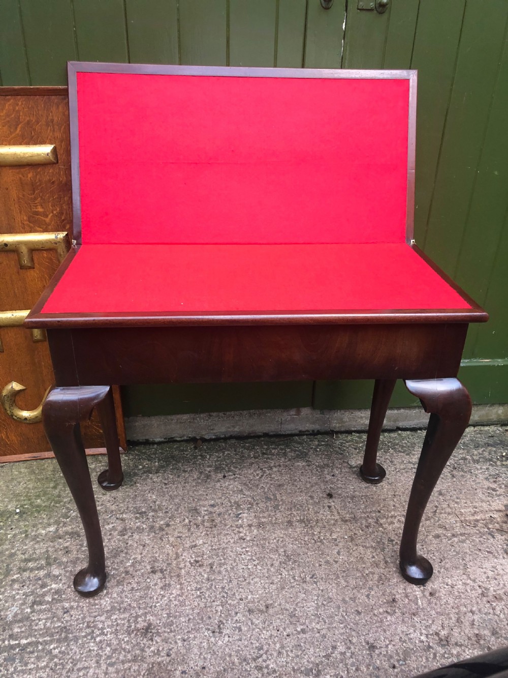 A mid-18th-century George II mahogany fold-over gaming table featuring elegant cabriole legs with pad feet. View V