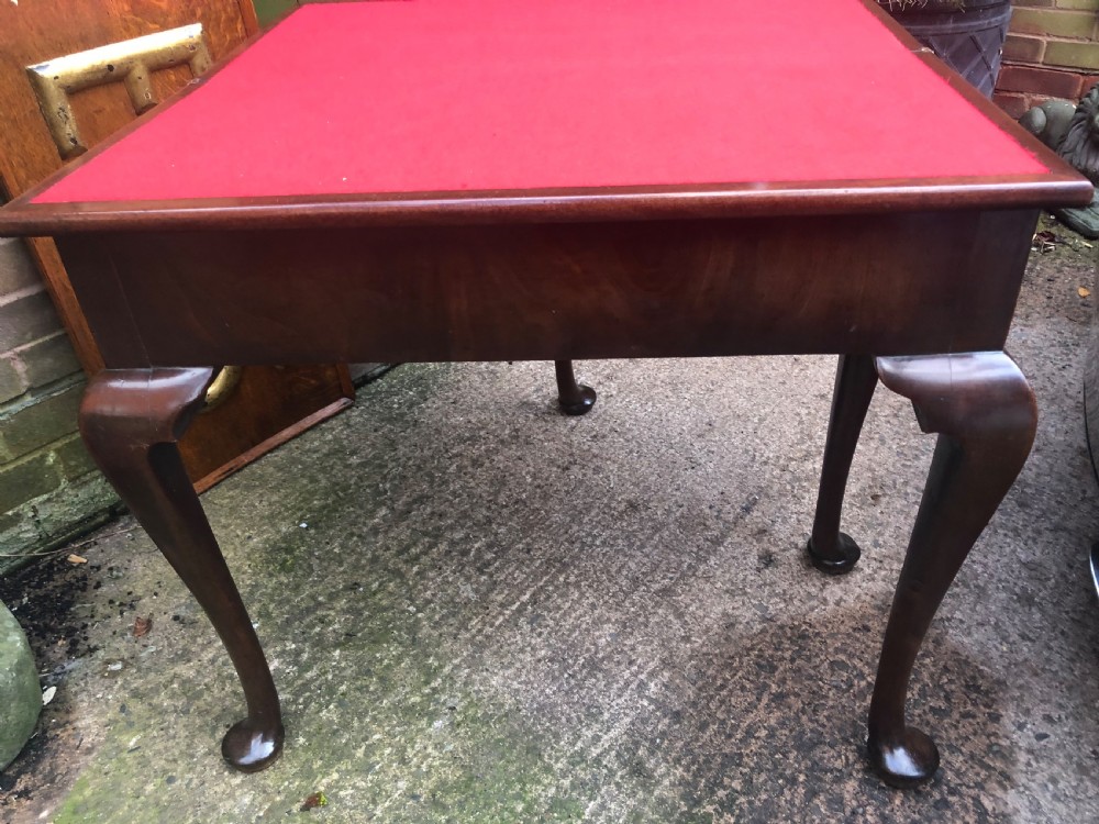 A mid-18th-century George II mahogany fold-over gaming table featuring elegant cabriole legs with pad feet. View XVIII