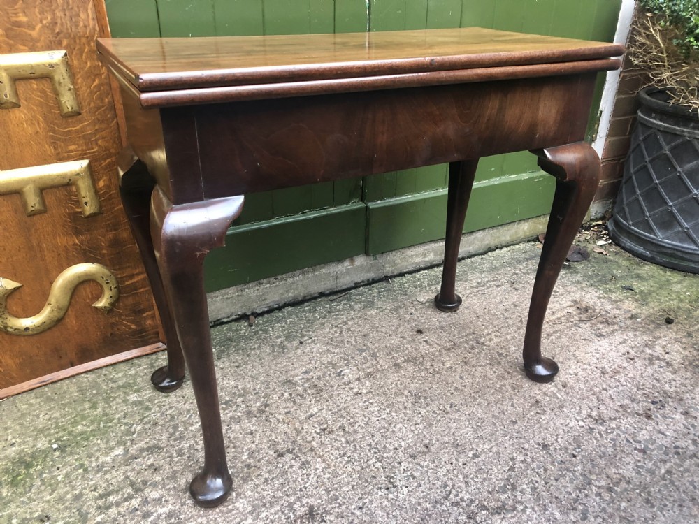 A mid-18th-century George II mahogany fold-over gaming table featuring elegant cabriole legs with pad feet. View II
