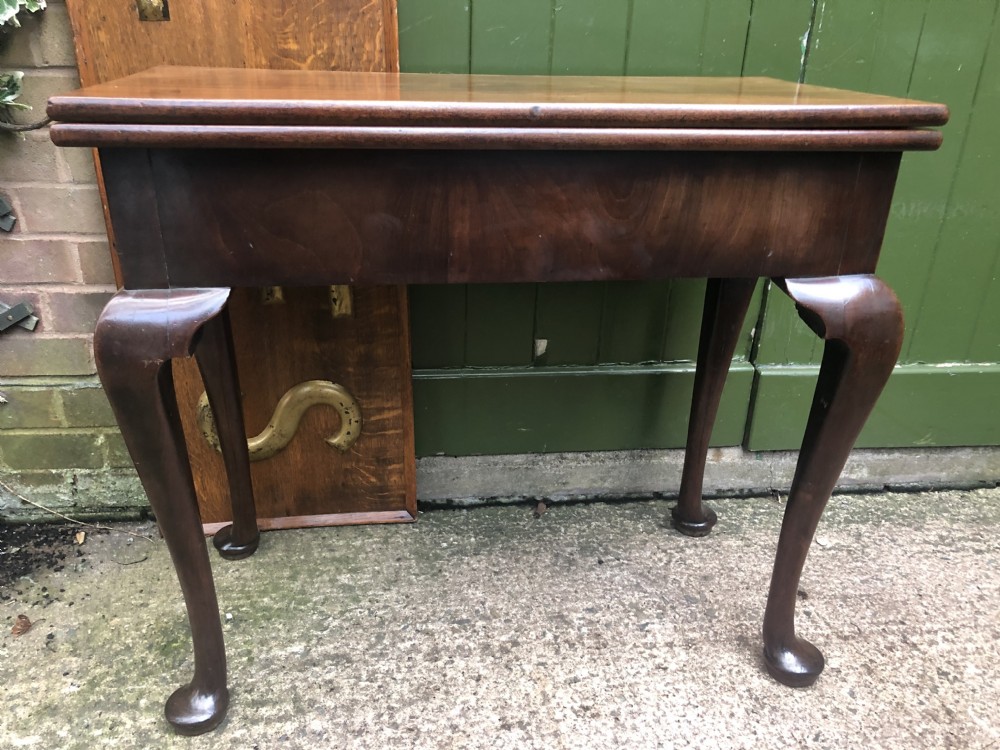 A mid-18th-century George II mahogany fold-over gaming table featuring elegant cabriole legs with pad feet. View XX
