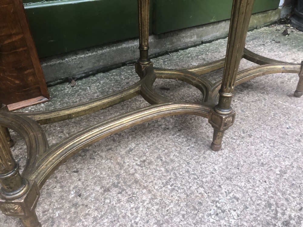 An early 20th-century French Louis XVI style low table with a green marble top, giltwood frame, fluted legs, and carved rosette details. View V
