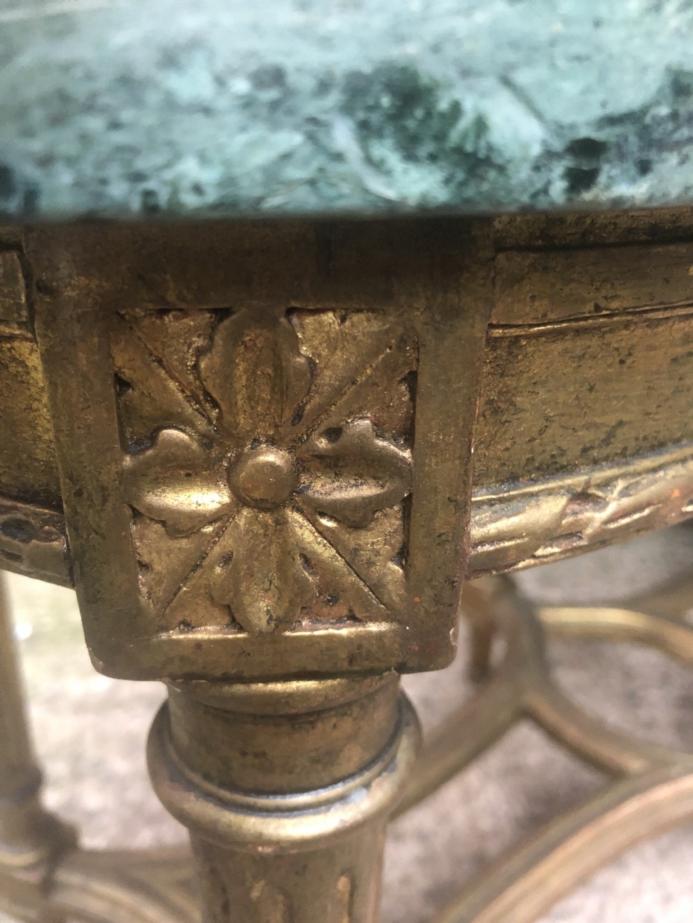 An early 20th-century French Louis XVI style low table with a green marble top, giltwood frame, fluted legs, and carved rosette details. View VII
