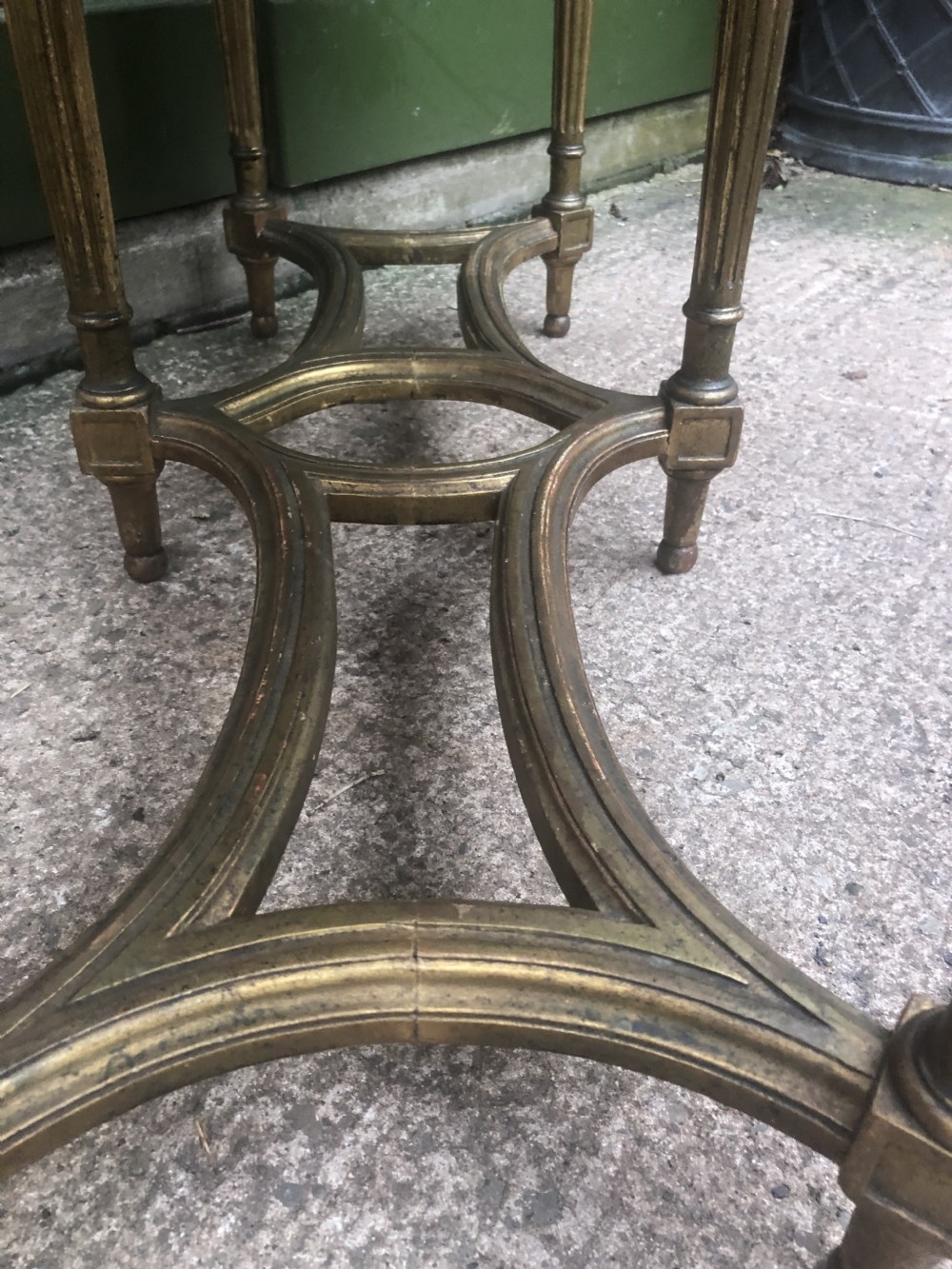An early 20th-century French Louis XVI style low table with a green marble top, giltwood frame, fluted legs, and carved rosette details. View VIII
