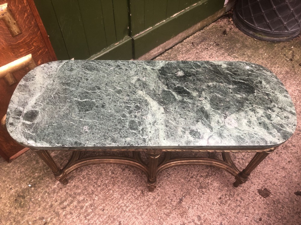An early 20th-century French Louis XVI style low table with a green marble top, giltwood frame, fluted legs, and carved rosette details. View XII