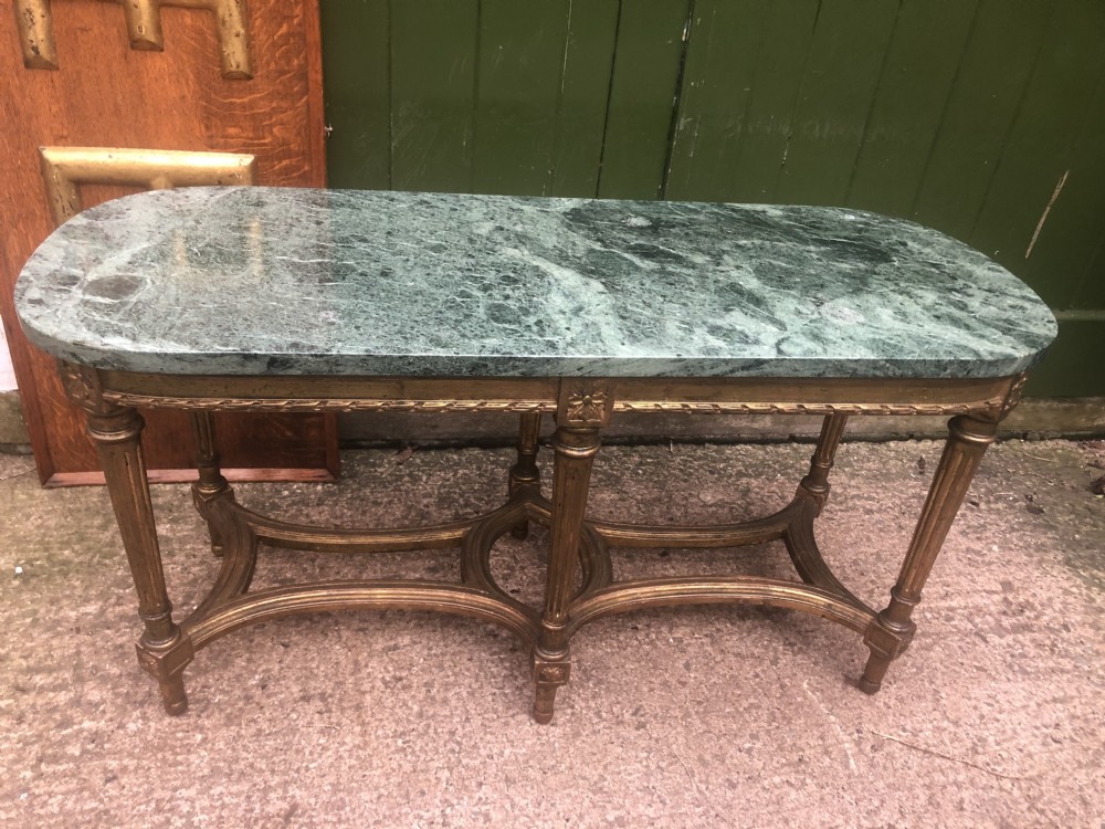 An early 20th-century French Louis XVI style low table with a green marble top, giltwood frame, fluted legs, and carved rosette details. View XIV