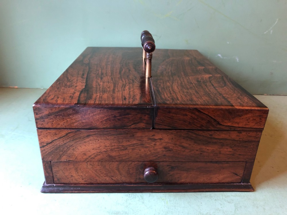 A dark rosewood rectangular desk tidy featuring a central turned wood and brass handle, hinged lids, and a moulded base. View II